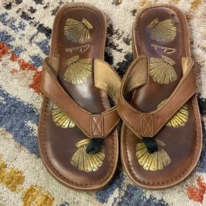 Clarks- brown leather flip flops- measure 9.75 inches ladies